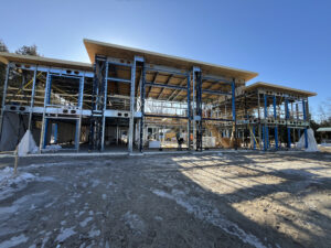 Steel frame home under construction — BONE Structure framing system showing precision cold-formed steel columns and roof structure